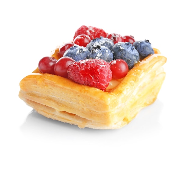 Delicious puff pastry with berries on white background