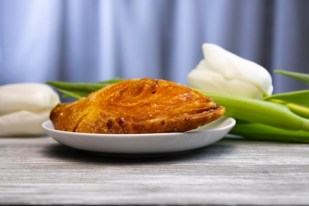 Delicious puff pastry with white tulips in the background