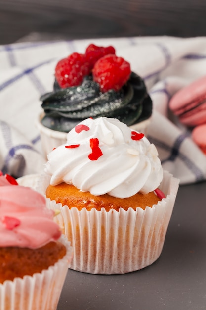 Delicious raspberry cupcakes on dark background - Handmade Sweet dessert