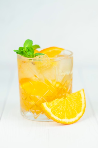 Delicious refreshing cocktail drink with alcohol and orange with mint leaf