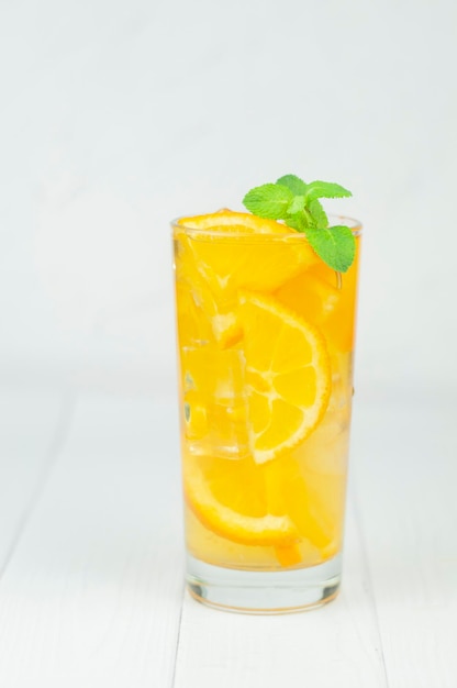 Delicious refreshing cocktail drink with alcohol and orange with mint leaf