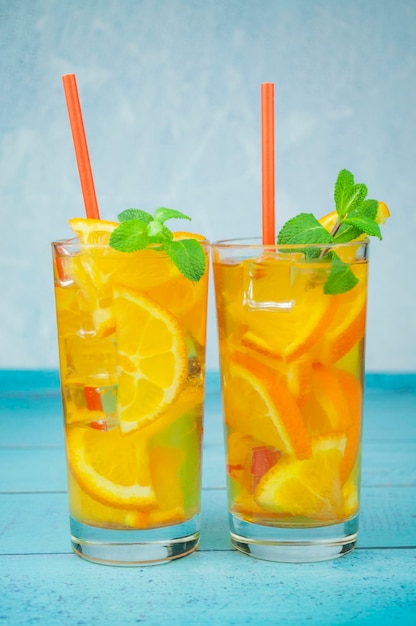 Delicious refreshing cocktail drink with alcohol and orange with mint leaf