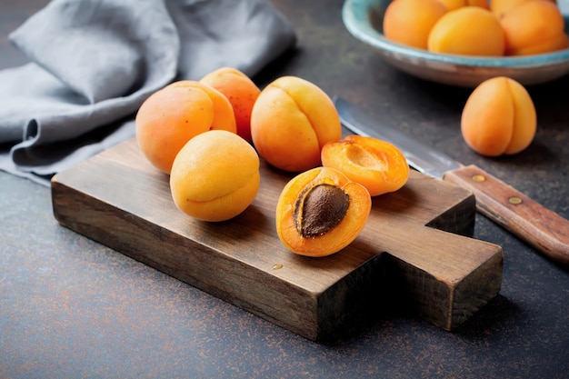 Delicious ripe apricots on a wooden stand