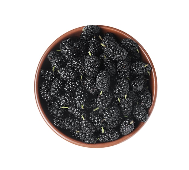 Delicious ripe black mulberries in bowl on white background top view