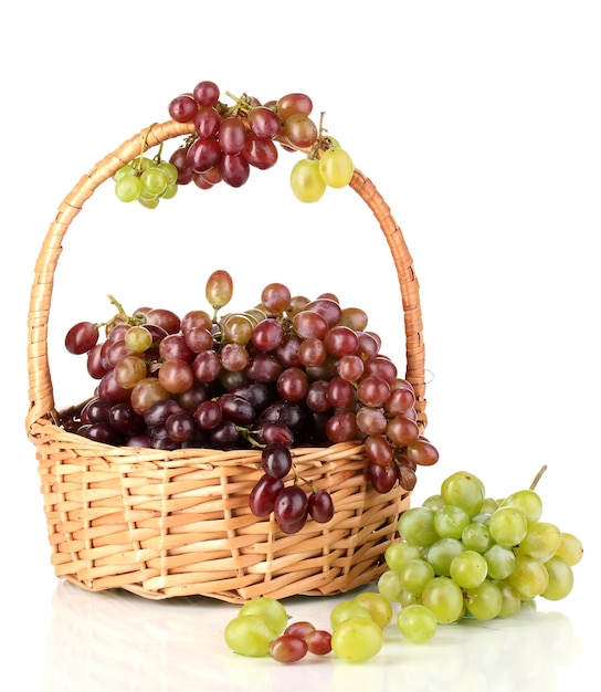 Delicious ripe pink and green grapes in basket isolated on white