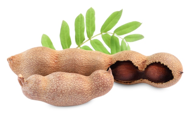 Delicious ripe tamarinds with leaves on white background Exotic fruit