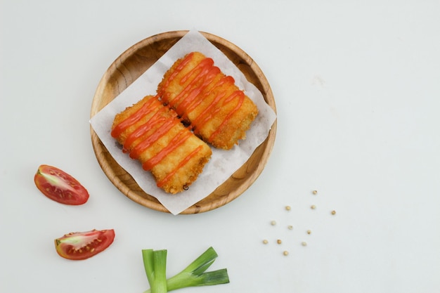 Delicious Risoles or Risol Mayo is a typical Indonesian traditional street food made from flour skin meat and vegetables stuffing inside with mayonnaise and chili sauce