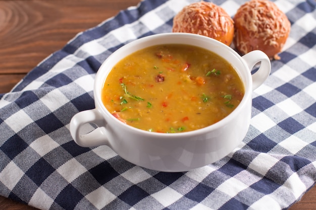 Delicious rustic soup with vegetables, lentils and peas