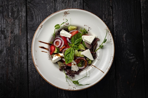 delicious salad in a plate on a dark table