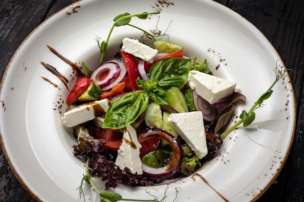 delicious salad in a plate on a dark table