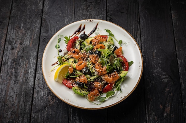 delicious salad in a plate on a dark table