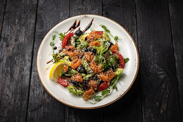 delicious salad in a plate on a dark table