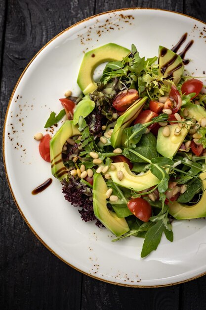 delicious salad in a plate on a dark table