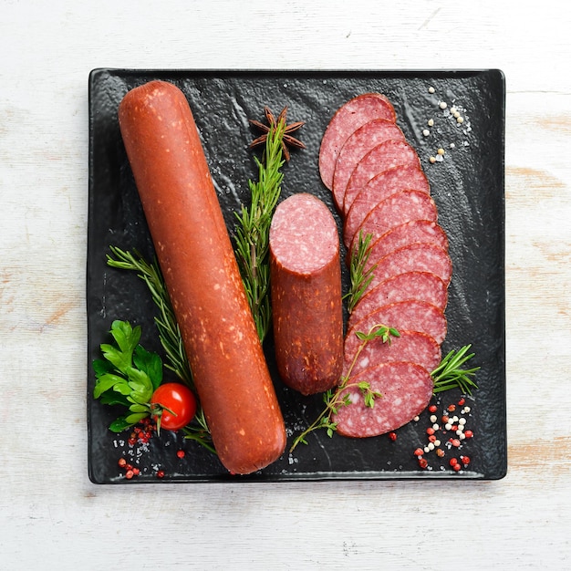 Delicious salami sausage with spices and rosemary Top view Free space for text