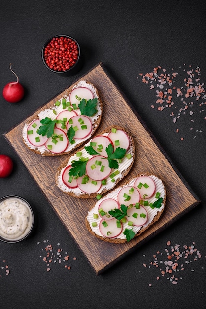 Delicious sandwich or bruschetta with cream cheese radish and green onions