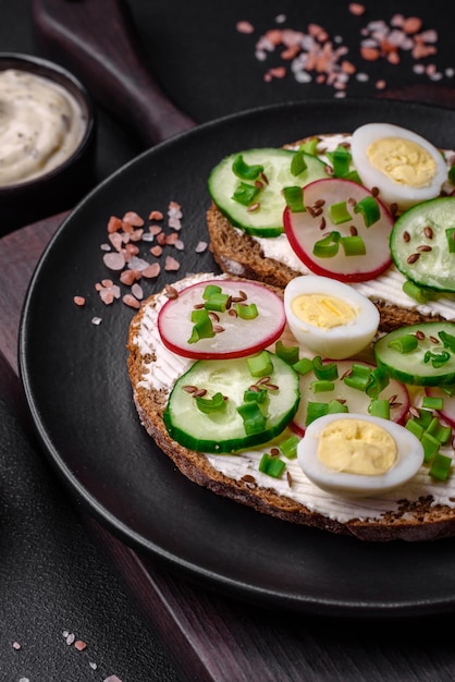 Delicious sandwich or bruschetta with cream cheese radish and green onions