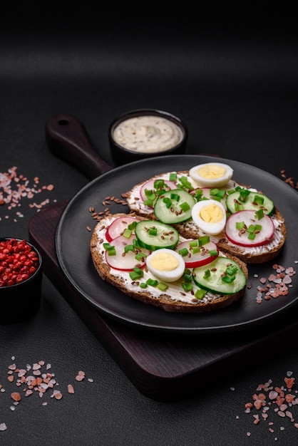 Delicious sandwich or bruschetta with cream cheese radish and green onions