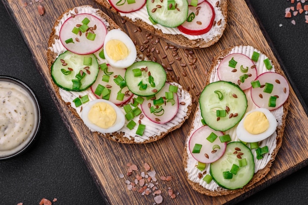 Delicious sandwich or bruschetta with cream cheese radish and green onions