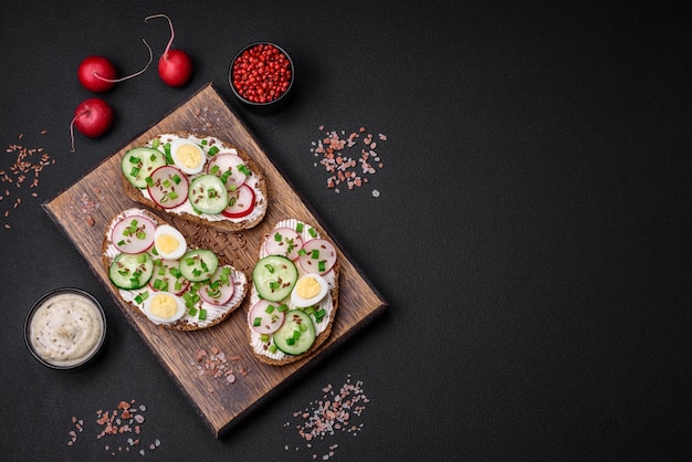 Delicious sandwich or bruschetta with cream cheese radish and green onions