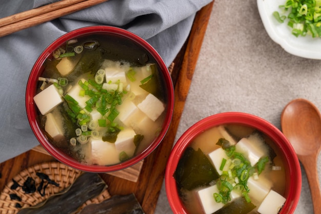 Delicious savory Japanese miso soup in a black bowl for eating