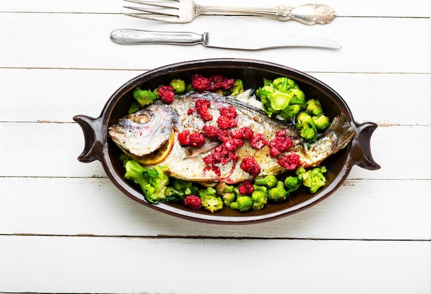 Delicious sea bream baked with raspberries and broccoli