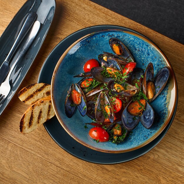 Delicious seafood mussels with sauce and parsley