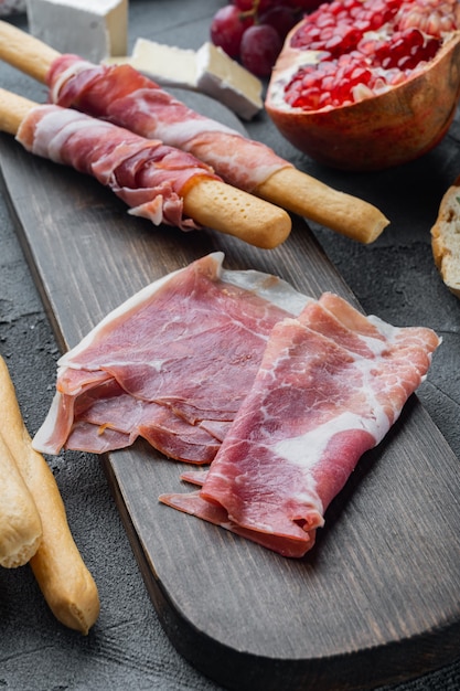 Delicious serrano ham jamon set, on gray background