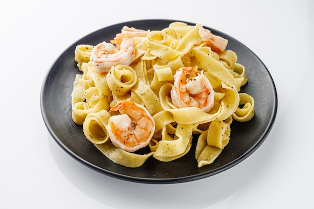 delicious shrimp fettuccine alfredo pasta on a white background