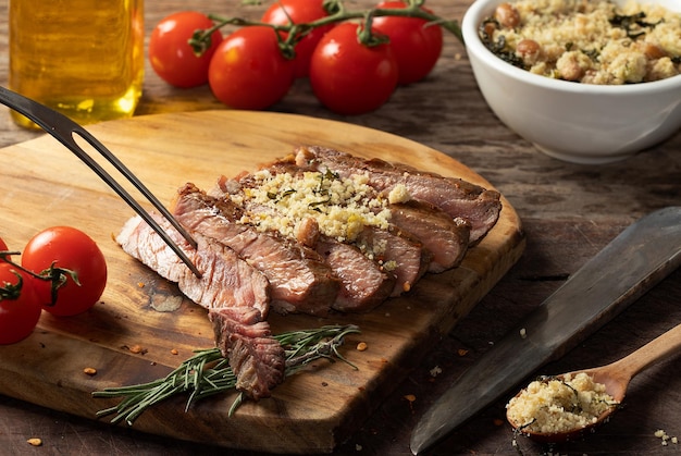 Delicious sliced grilled beef with toasted manioc flour Selective focus