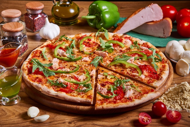 Delicious sliced italian pizza served on wooden table.  tasty pizza composition