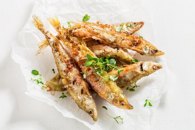 Delicious smelt fish and chips with salt and herbs