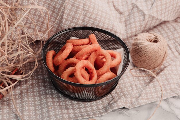 Delicious snack plate, french fries, onion rings, spring rolls or sausages on the table