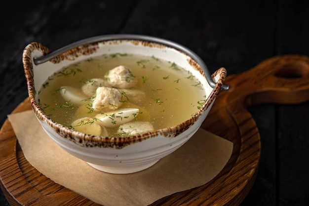 delicious soup with meatballs on a dark table