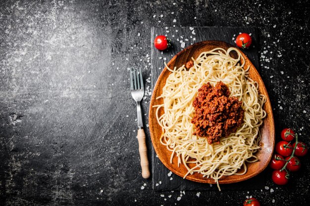 Delicious spaghetti bolognese in a bowl with cherry tomatoes