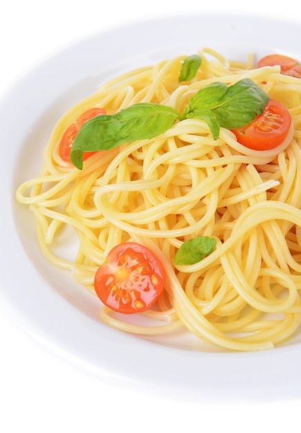 Delicious spaghetti with tomatoes on plate closeup