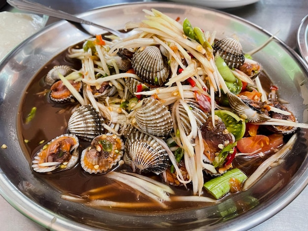 Delicious spicy cockle salad on plate