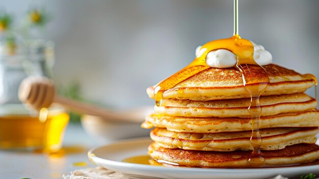 Delicious stack of pancakes drizzled with golden syrup and topped with whipped cream