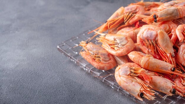 Delicious steamed shrimps on a plate with text space