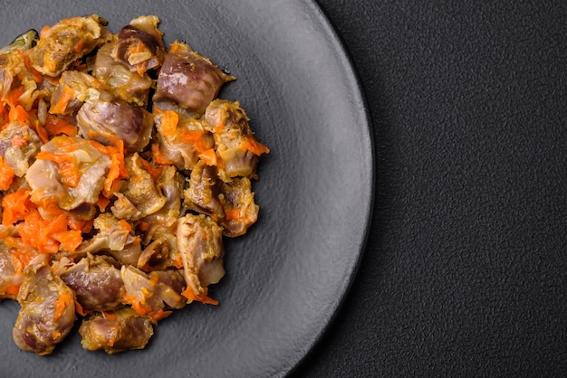 Delicious stewed chicken gizzards with carrots and tomato