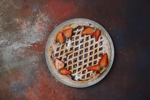 delicious strawberry tart on a grey background top view