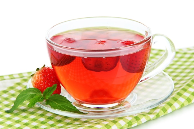 Delicious strawberry tea on table on white background