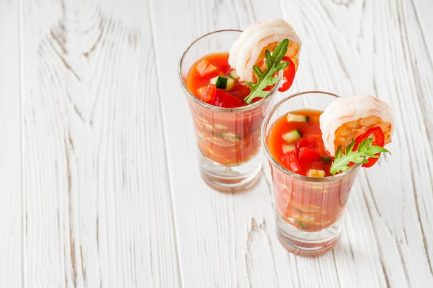 delicious summer gazpacho cocktail on a white wooden rustic background