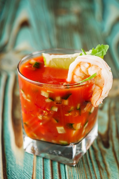 delicious summer gazpacho cocktail on a wooden rustic background