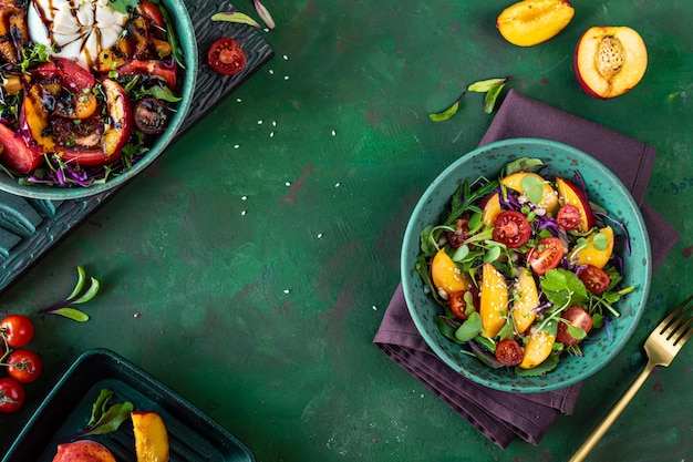 Delicious summer salad with burrata cheese and grilled peaches arugula and microgreens