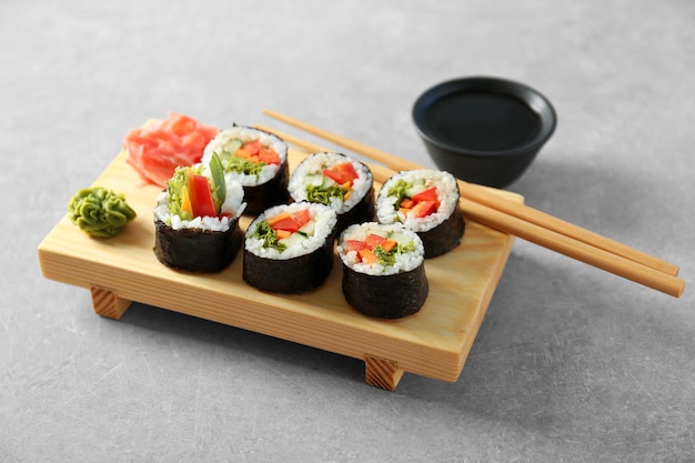 Delicious sushi rolls on table