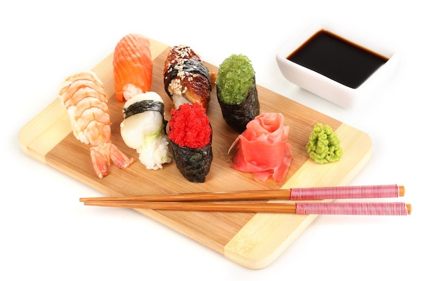 Delicious sushi served on wooden board isolated on white