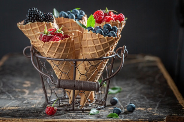 Delicious and sweet berries in waffels as concept of ice cream Forest fruits and wafers