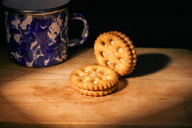 Delicious sweet chocolate cookies on a wooden table with low light