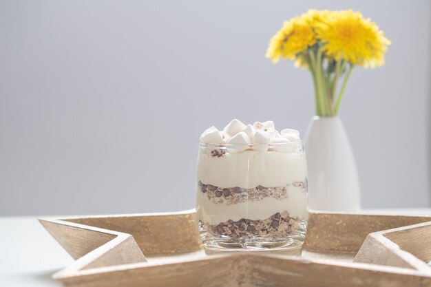 Delicious sweet dessert with cream in a glass on a light background a beautiful breakfast