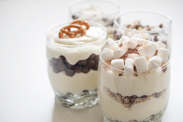 Delicious sweet dessert with cream in a glass on a light background a beautiful breakfast